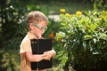 Portrait Happy little boy holding a big book on his first day to school or nursery. Outdoors, Back to school concept Royalty Free Stock Photo