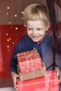Portrait of a happy little boy holding a new gift. Christmas. Birthday