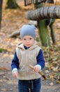 Portrait of happy little boy playing with tree branch Royalty Free Stock Photo