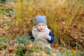 Portrait of happy little boy playing with yellow autumn leafs at natural park Royalty Free Stock Photo
