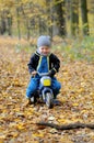 Portrait of a happy little boy riding a motorbike