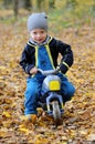 Portrait of a happy little boy riding his motorbike