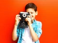 Portrait happy little boy teenager with retro camera on red Royalty Free Stock Photo