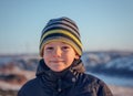 Portrait Happy little boy winter clothing having fun in fresh white winter snow in evening light Royalty Free Stock Photo