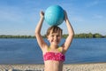 Portrait of a happy little girl with ball on the beach. Lifestyle Royalty Free Stock Photo