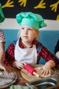 Portrait of a happy little girl in a chef`s cap Royalty Free Stock Photo