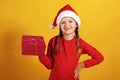 Portrait of happy little girl with a Christmas present. The child holds a box with a gift Royalty Free Stock Photo