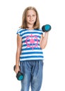 Portrait of happy little girl with dumbbells posing in studio Royalty Free Stock Photo