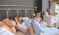 Relaxed little girl eating cookies over the bed Royalty Free Stock Photo