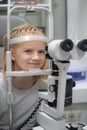 portrait happy little girl patient ophthalmology clinic, vision test in progress cheerful child an optometric