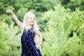 Portrait of happy little girl posing in blue dotted dress