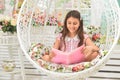 Happy little girl reading book on swing Royalty Free Stock Photo