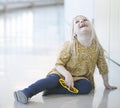 Portrait of happy little girl sitting on wall and laughing Royalty Free Stock Photo