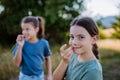 Portrait of a happy little girls chilling and enjoying summer nature. Royalty Free Stock Photo