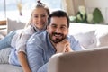 Portrait of happy little school aged girl lying on father`s back. Royalty Free Stock Photo