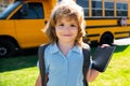 Portrait of happy little schoolboy pupil outdoor on school bus. Royalty Free Stock Photo