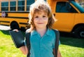 Portrait of happy little schoolboy pupil outdoor on school bus. Royalty Free Stock Photo