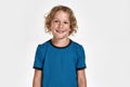 Portrait of happy little sportive boy child in sportswear smiling at camera while posing, standing isolated over white Royalty Free Stock Photo