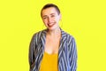 Portrait of happy lively young short hair beautiful hipster woman in yellow shirt and striped suit standing and looking at camera