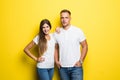 Portrait of happy lovely couple smiling and posing on camera together over yellow background Royalty Free Stock Photo