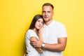 Portrait of happy lovely couple smiling and posing on camera together over yellow background Royalty Free Stock Photo