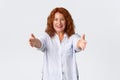 Portrait of happy and lovely redhead middle-aged woman extend hands, reaching arms for hug, mother wanting to cuddle or