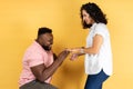 Happy couple standing together romantic man puts on a wedding ring to her girlfriend making proposal Royalty Free Stock Photo