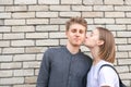 Portrait of happy lovers couple against the background of a brick wall Royalty Free Stock Photo