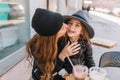 Portrait happy loving family together. Mother and her daughter sitting in a city cafe and playing and hugging. Happy Royalty Free Stock Photo