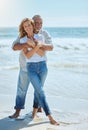 Portrait of a happy and loving mature couple enjoying a day at the beach in summer. Cheerful affectionate senior husband Royalty Free Stock Photo