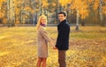 Portrait of happy loving young couple together in autumn park on warm sunny day Royalty Free Stock Photo