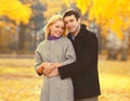 Portrait of happy loving young couple together in autumn park on warm sunny day Royalty Free Stock Photo