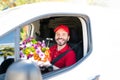 Portrait of a happy male courier holding a bouquet of flowers Royalty Free Stock Photo