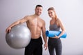 Male And Female Sports Person Holding Exercise Ball And Mat Royalty Free Stock Photo