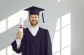 Portrait of happy male graduate student standing with diploma Royalty Free Stock Photo