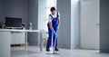 Portrait Of Happy Male Janitor Cleaning Floor Royalty Free Stock Photo