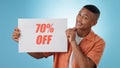 Portrait, happy man and board with sale in studio on blue background for mock up with discount, promo or offer. Cape