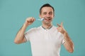 Portrait of Happy Man Brushing Teeth on Blue Royalty Free Stock Photo