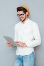 Portrait of a happy man in eyeglasses using tablet computer Royalty Free Stock Photo