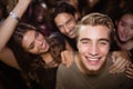 Portrait of happy man with friends at nightclub Royalty Free Stock Photo