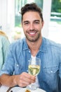 Portrait of happy man holding white wine glass Royalty Free Stock Photo