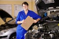 Portrait, happy man and mechanic with checklist on engine of car, repair or maintenance. Smile, technician and person