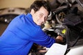 Portrait, happy man and mechanic with document on engine of car, repair or maintenance. Smile, face and technician with