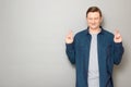 Portrait of happy man raising crossed fingers and hoping for victory Royalty Free Stock Photo