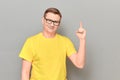 Portrait of happy man raising index finger up and making notice Royalty Free Stock Photo