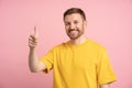 Portrait happy man showing thumb up on pink background looking at camera on banner. Royalty Free Stock Photo