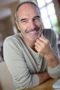 Portrait of an happy man sitting at home Royalty Free Stock Photo