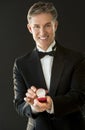 Portrait Of Happy Man In Tuxedo Holding Ring Box