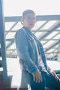 Portrait of happy man wearing denim jacket smiling  on city street , Young bearded hipster businessman Royalty Free Stock Photo