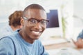 Portrait of happy man wearing eyeglasses while sitting at desk Royalty Free Stock Photo